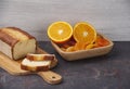 Orange cake on a kitchen board with a sliced Ã¢â¬â¹Ã¢â¬â¹orange and apricot in a wooden bowl, copy space Royalty Free Stock Photo